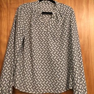 Blouse with long sleeves white with black geometric designs.